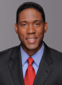 A man in a suit and red tie.